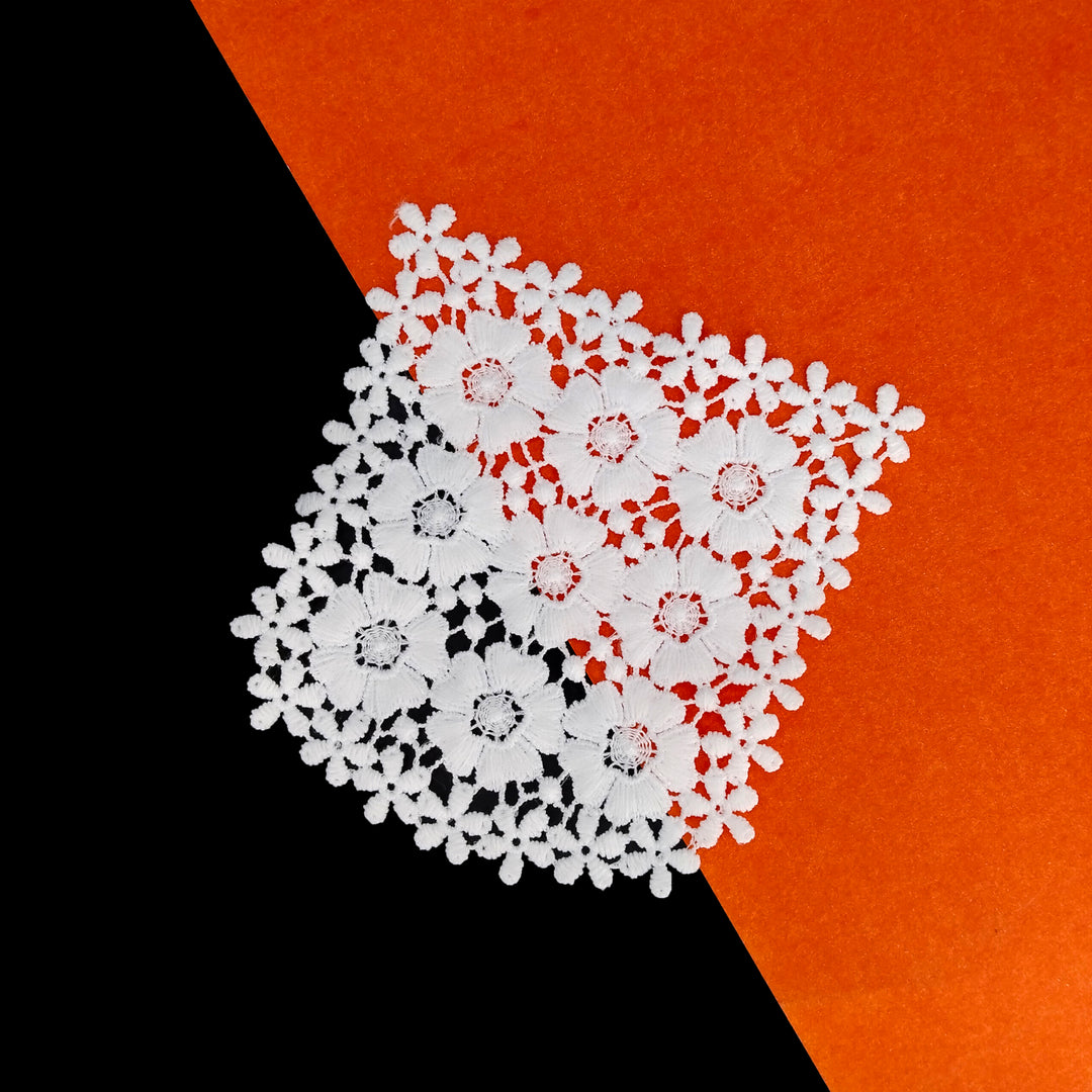 ANI Accessories white flower patch design tilted on a black and orange background 
