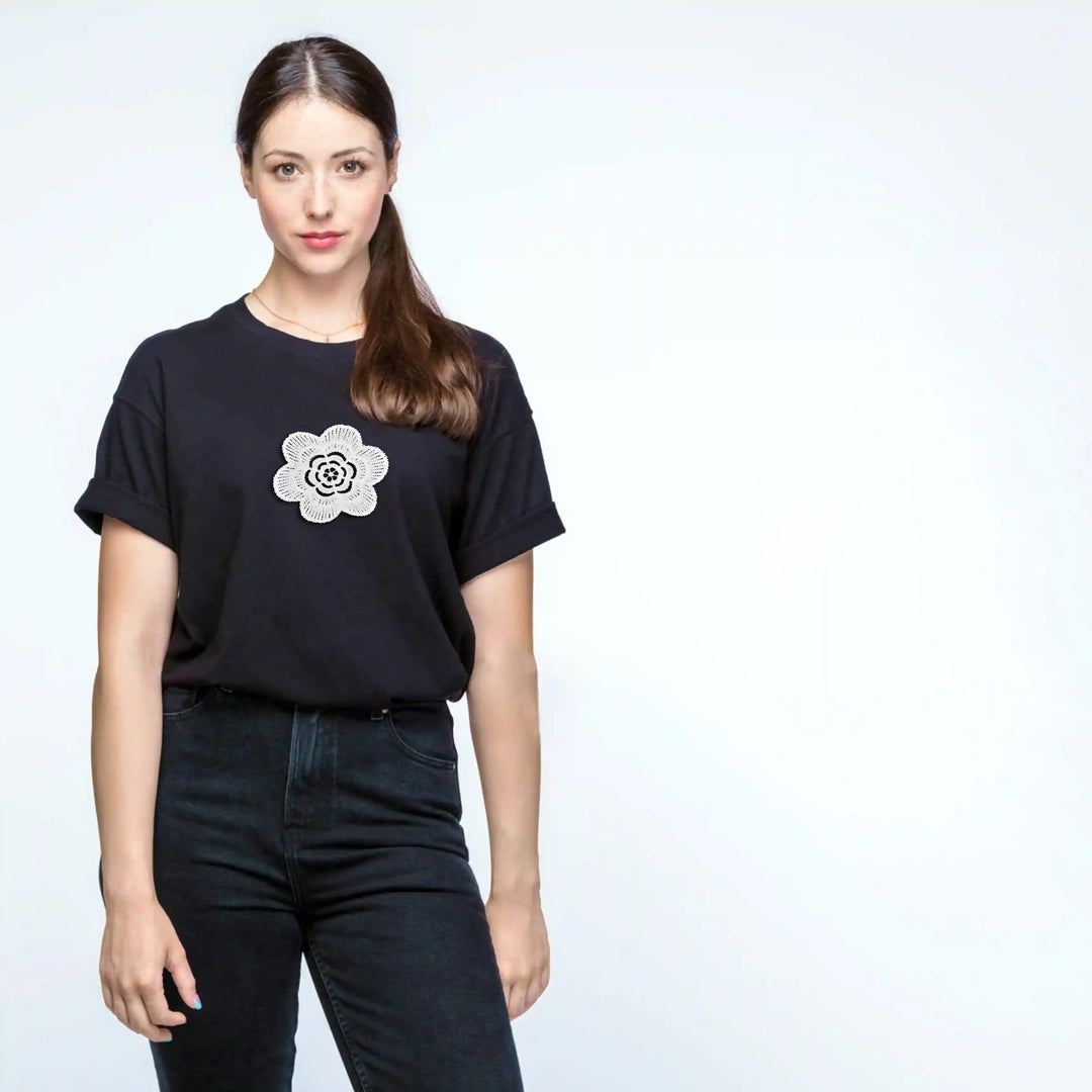 ANI Accessories white flower patch for t-shirt on the chest of a black tee