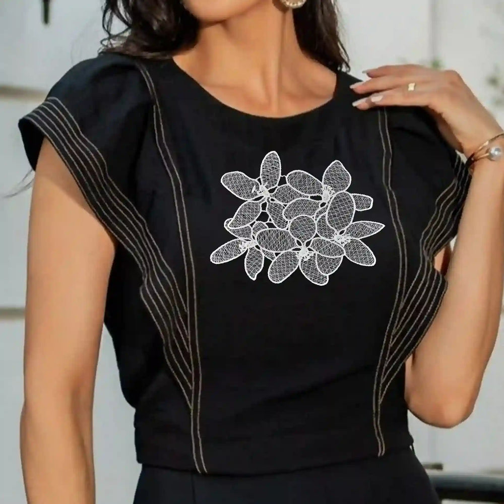 ANI Accessories white flower patch stitched on the chest of a black top 