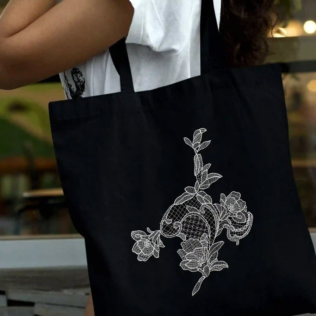ANI Accessories white flower patch for bag stitched on a black tote bag 