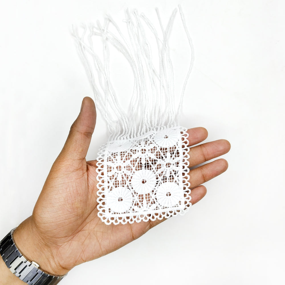 ANI Accessories white flower patch with fringe held in an open palm to show its size 
