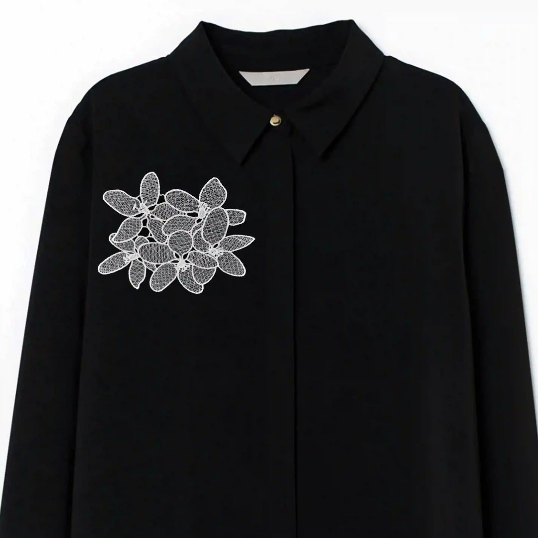 ANI Accessories white flowers patch stitched on the chest of a black shirt 