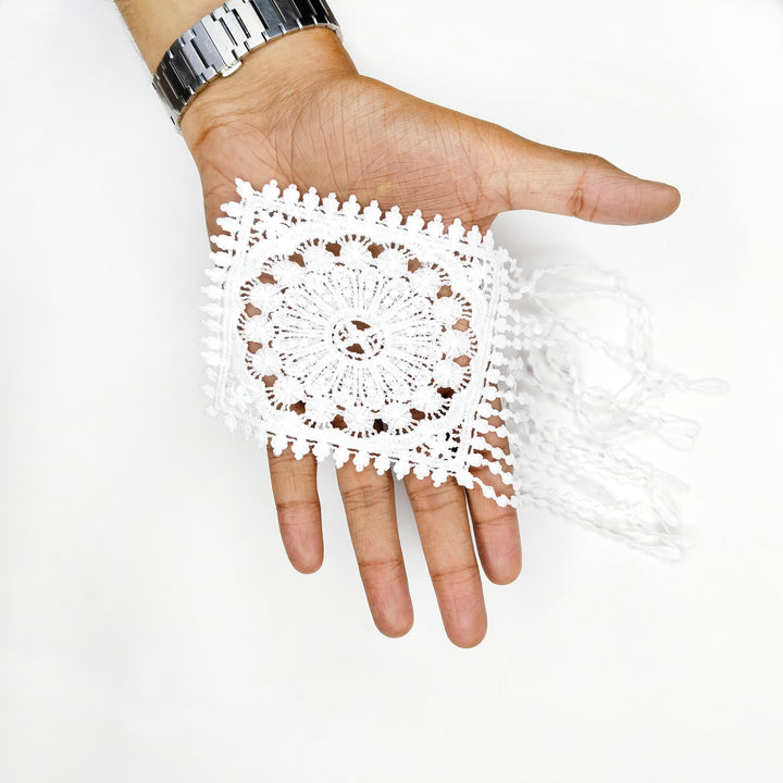 ANI Accessories white medallion patch with hanging strands draped over a hand to show its size with white color background 