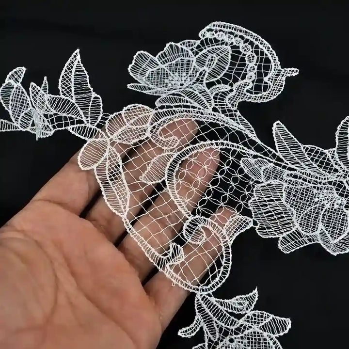 ANI Accessories white flower patch held over a hand to show its see-through thread work 