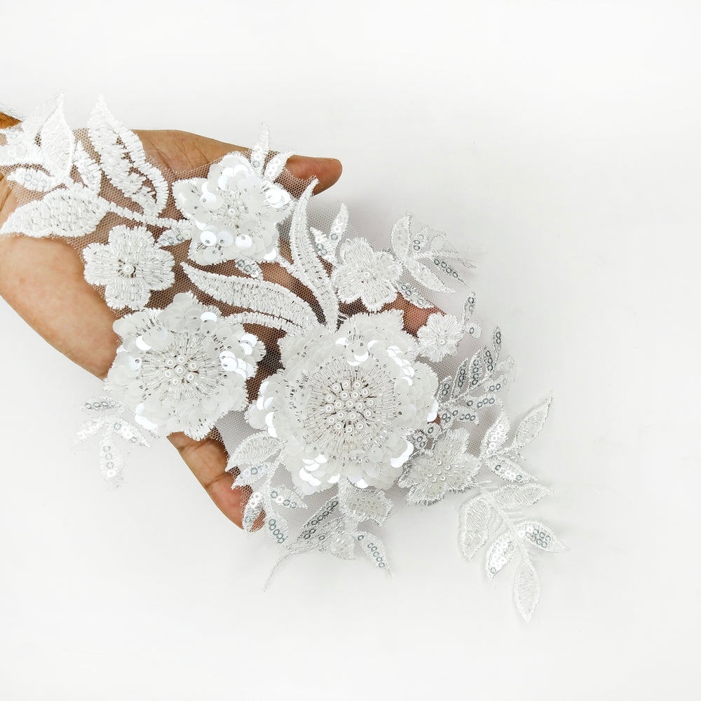 ANI Accessories white sequin flower patch held in a hand to show its raised petals 