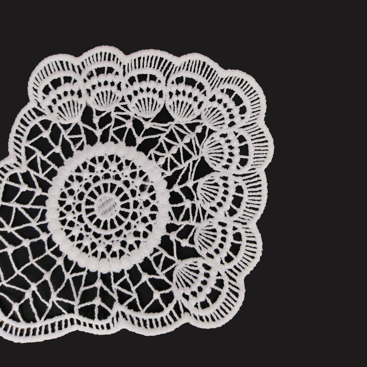 ANI Accessories close view of white sew on patch showing the eyelet medallion and web bars 