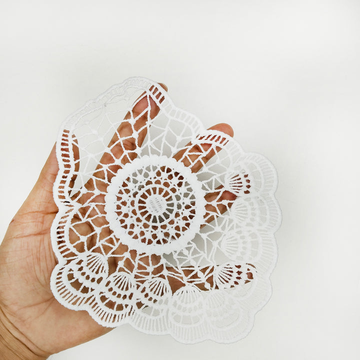 ANI Accessories white spun poly patch held in hand to show its size and open web pattern 