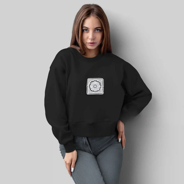 ANI Accessories white square dress patch stitched on the chest of a black sweatshirt 