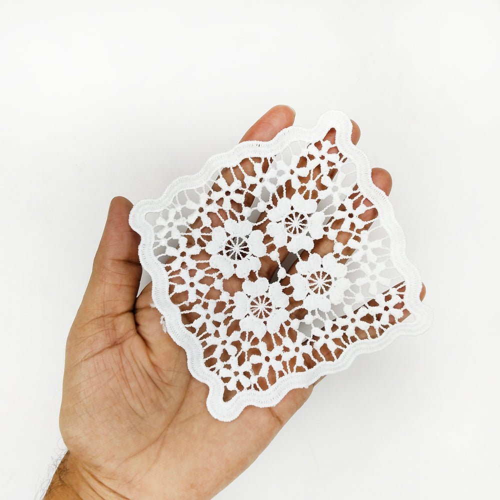 White wavy edge flower patch held in hand to show its 4 inch size 